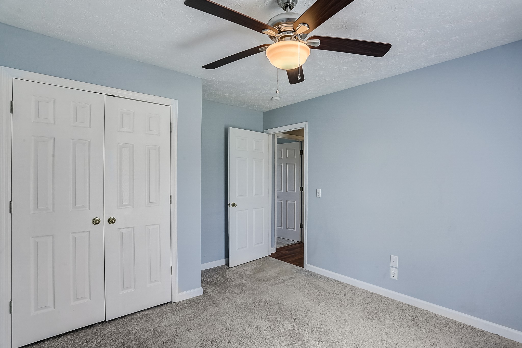 106 Vanatta Road Portland, TN 37148 - Photo 16 of 31 an empty room with closet and a chandelier fan