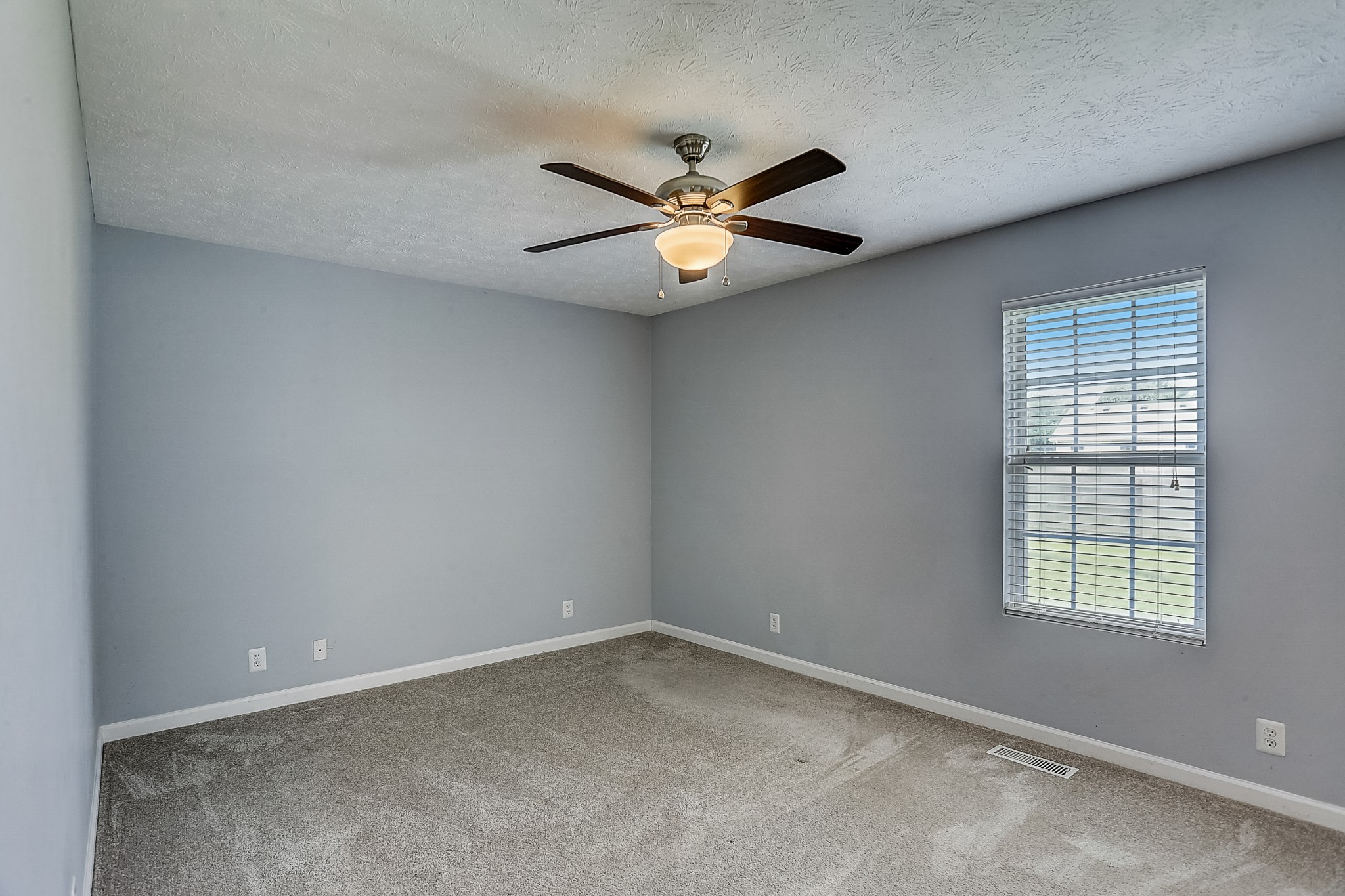 106 Vanatta Road Portland, TN 37148 - Photo 20 of 31 an empty room with a window and a fan