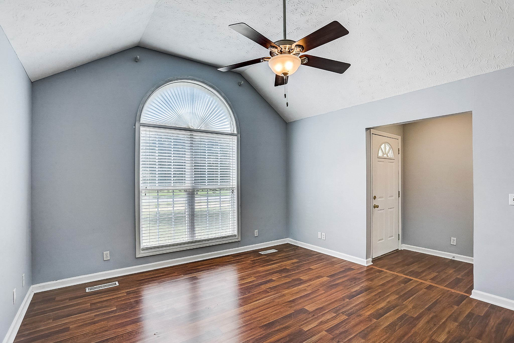 106 Vanatta Road Portland, TN 37148 - Photo 4 of 31 an empty room with wooden floor fan and window