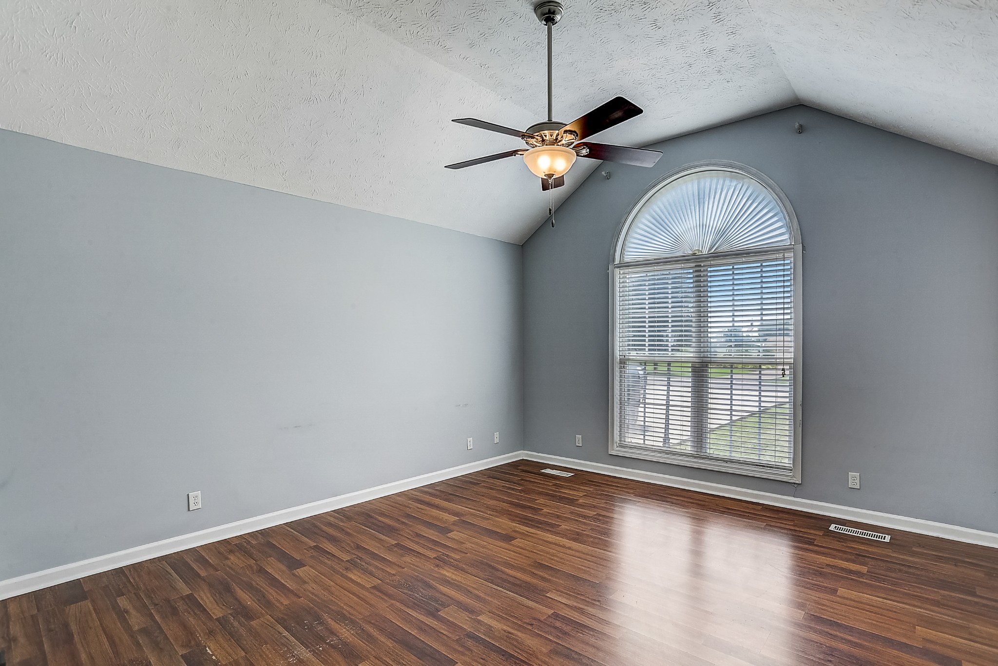 106 Vanatta Road Portland, TN 37148 - Photo 7 of 31 an empty room with wooden floor chandelier and windows