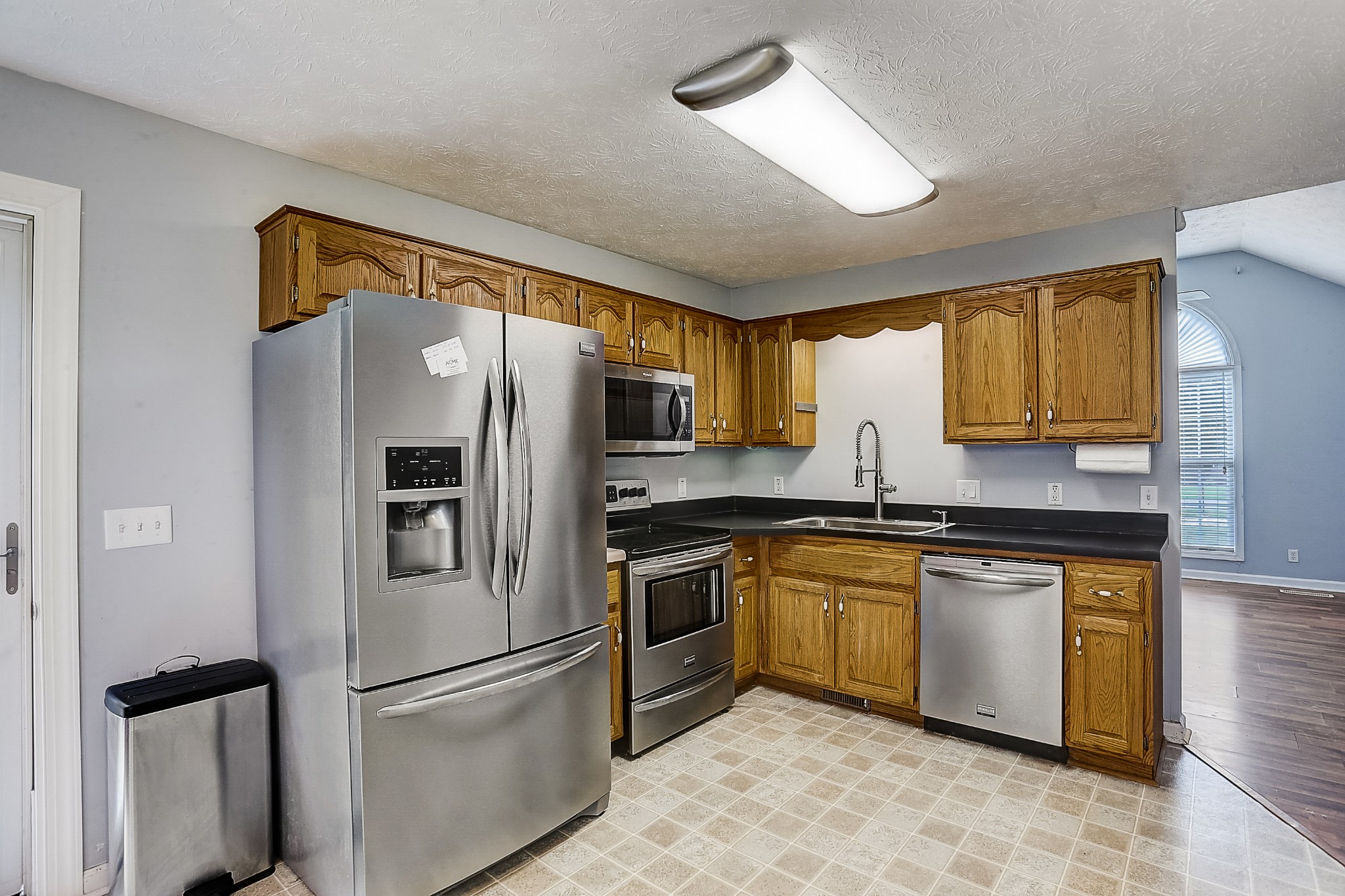 106 Vanatta Road Portland, TN 37148 - Photo 8 of 31 a kitchen with stainless steel appliances granite countertop a refrigerator a stove a sink and a microwave