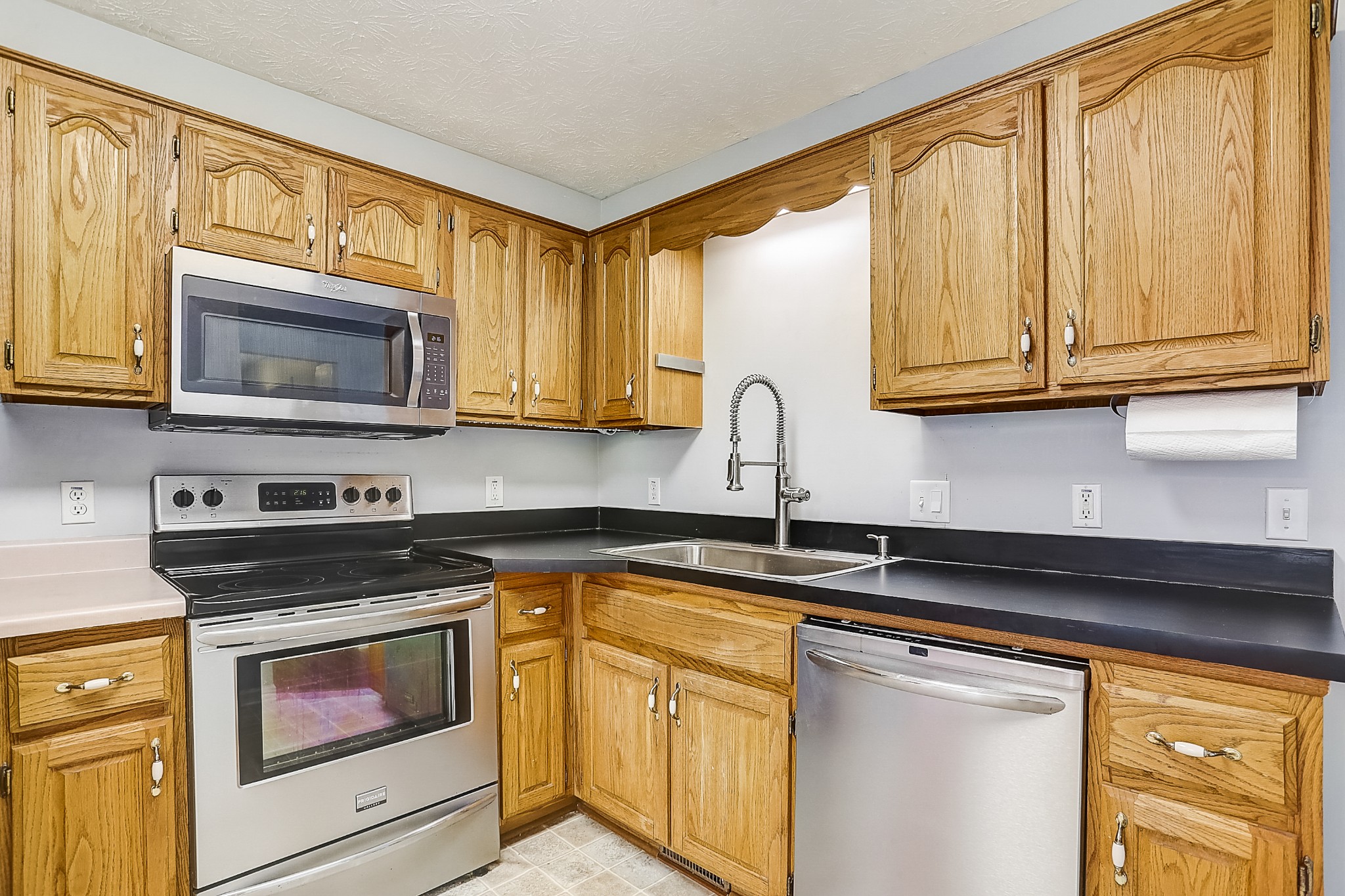 106 Vanatta Road Portland, TN 37148 - Photo 9 of 31 a kitchen with granite countertop cabinets stainless steel appliances a sink and a window