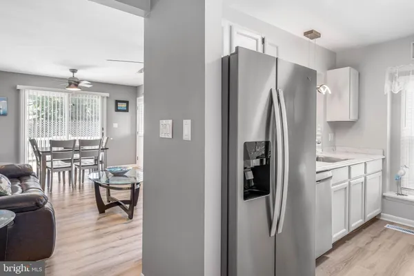 a kitchen with stainless steel appliances a refrigerator and wooden cabinets