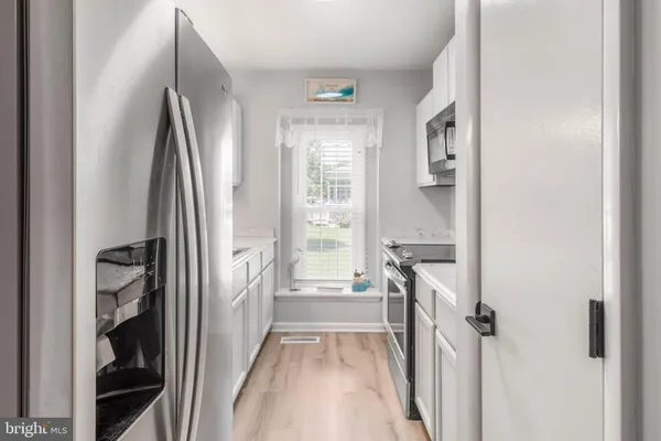 a view of a kitchen from the hallway