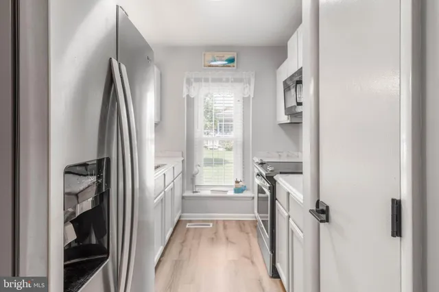 a view of a kitchen from the hallway