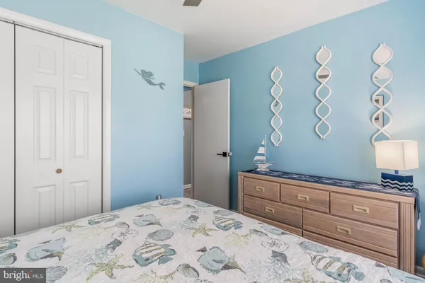 a bedroom with a bed and a dresser in it