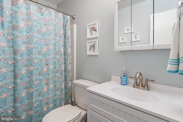 a white toilet sitting next to a bathroom sink