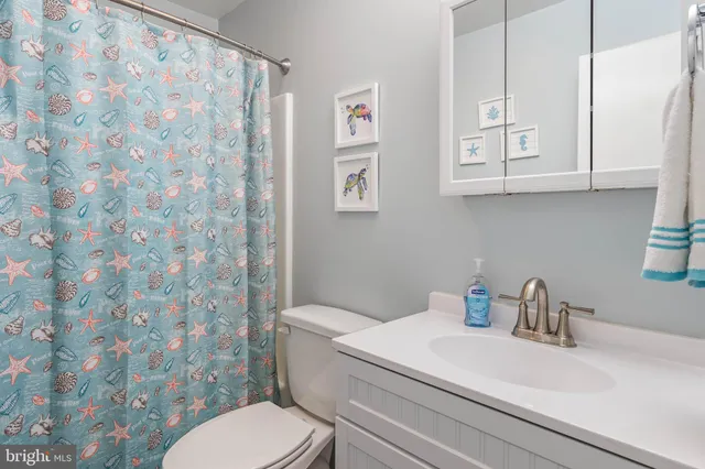a white toilet sitting next to a bathroom sink