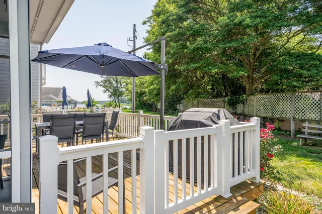 a view of deck with chairs and wooden fence