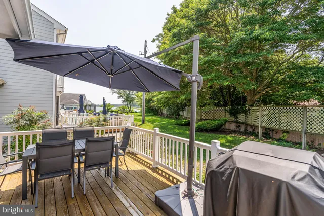 a view of a house with a yard and potted plants