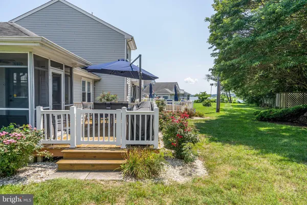 a front view of a house with a yard table and chairs