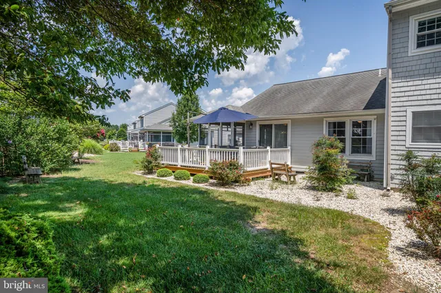 a view of house with yard and green space