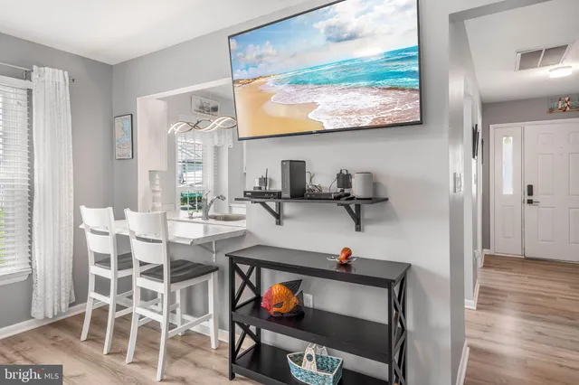 a living room with furniture a window and appliances