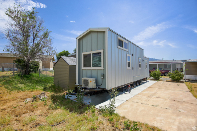 111 Barrington Way Layton, UT 84041 - Photo 10 of 10 Modern tiny home with light blue board-and-batten siding and a shed roof