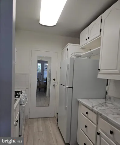 a kitchen with a refrigerator and cabinets