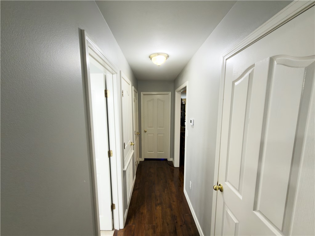 164 Park Road Russellville, AR 72802 - Photo 15 of 35 Hallway featuring wood-finish flooring, light gray walls, and white trim