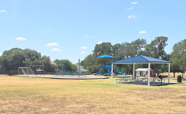 a view of a swimming pool with a patio and a tub