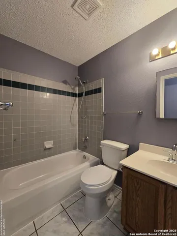 a bathroom with a toilet a sink and bathtub