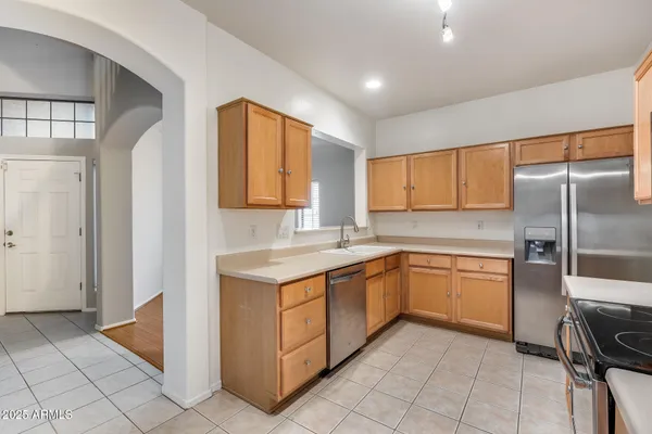 a kitchen with a sink cabinets and appliances
