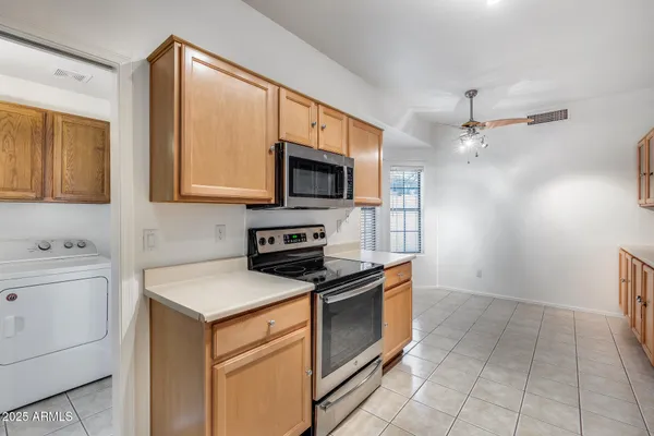 a kitchen with a stove a sink and a microwave