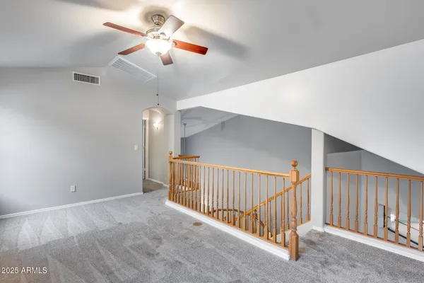 a view of a livingroom with a ceiling fan and window