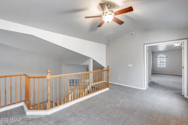 a view of a hallway with a ceiling fan