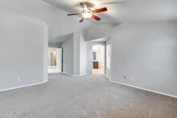 a view of a room with a ceiling fan and a chandelier fan