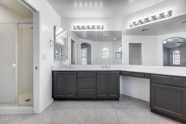 a bathroom with a granite countertop sink a large mirror and a vanity