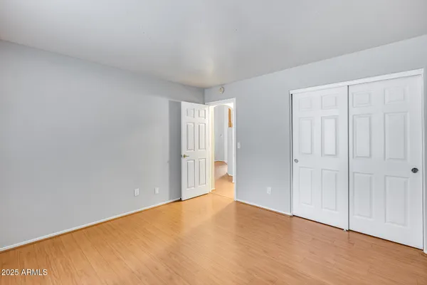 a view of an empty room and wooden floor