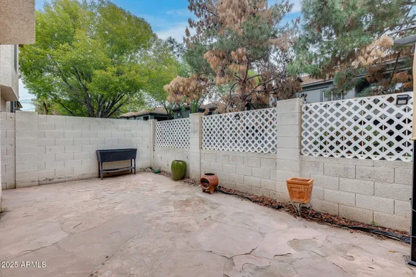 a view of backyard and wooden fence