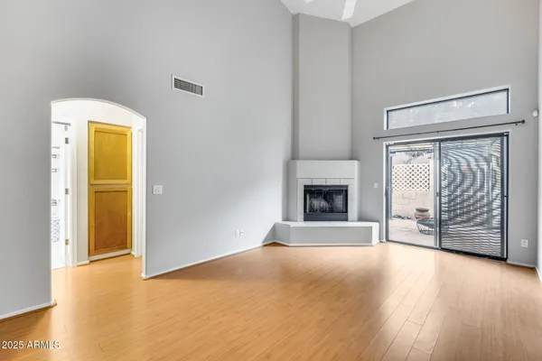 a view of an empty room with a fireplace and a window