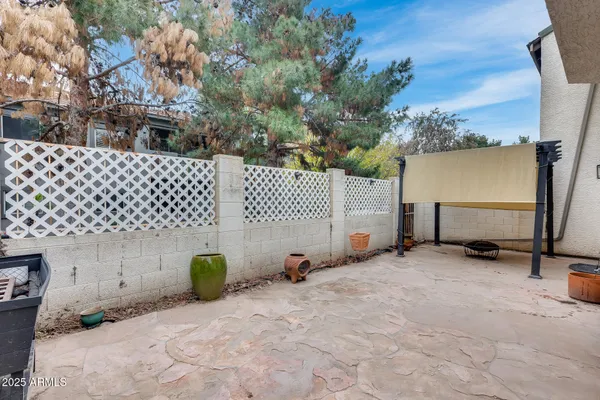 a backyard of a house with barbeque oven fire pit and outdoor seating