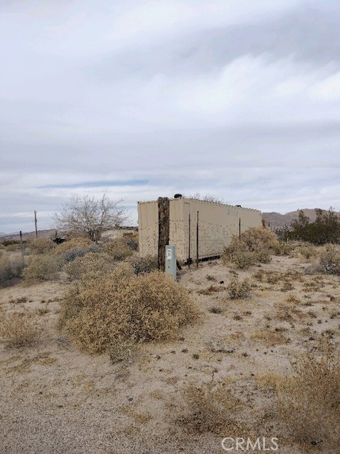 10313 Lake Road Cantil, CA 93519 - Photo 22 of 31 a view of a dry yard with wooden fence