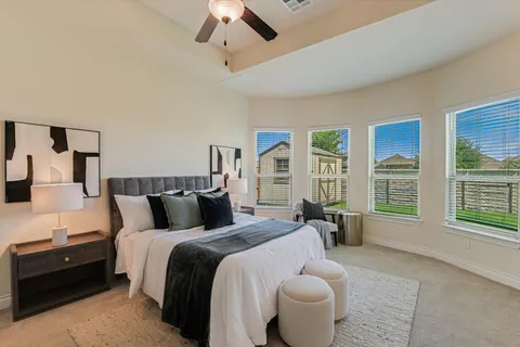 a bedroom with a large bed and a large window