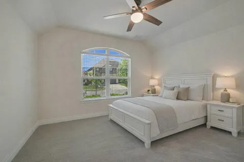 a bedroom with a bed and a window