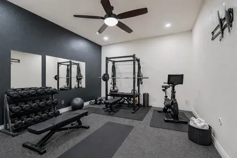 a living room with furniture gym equipment and a window