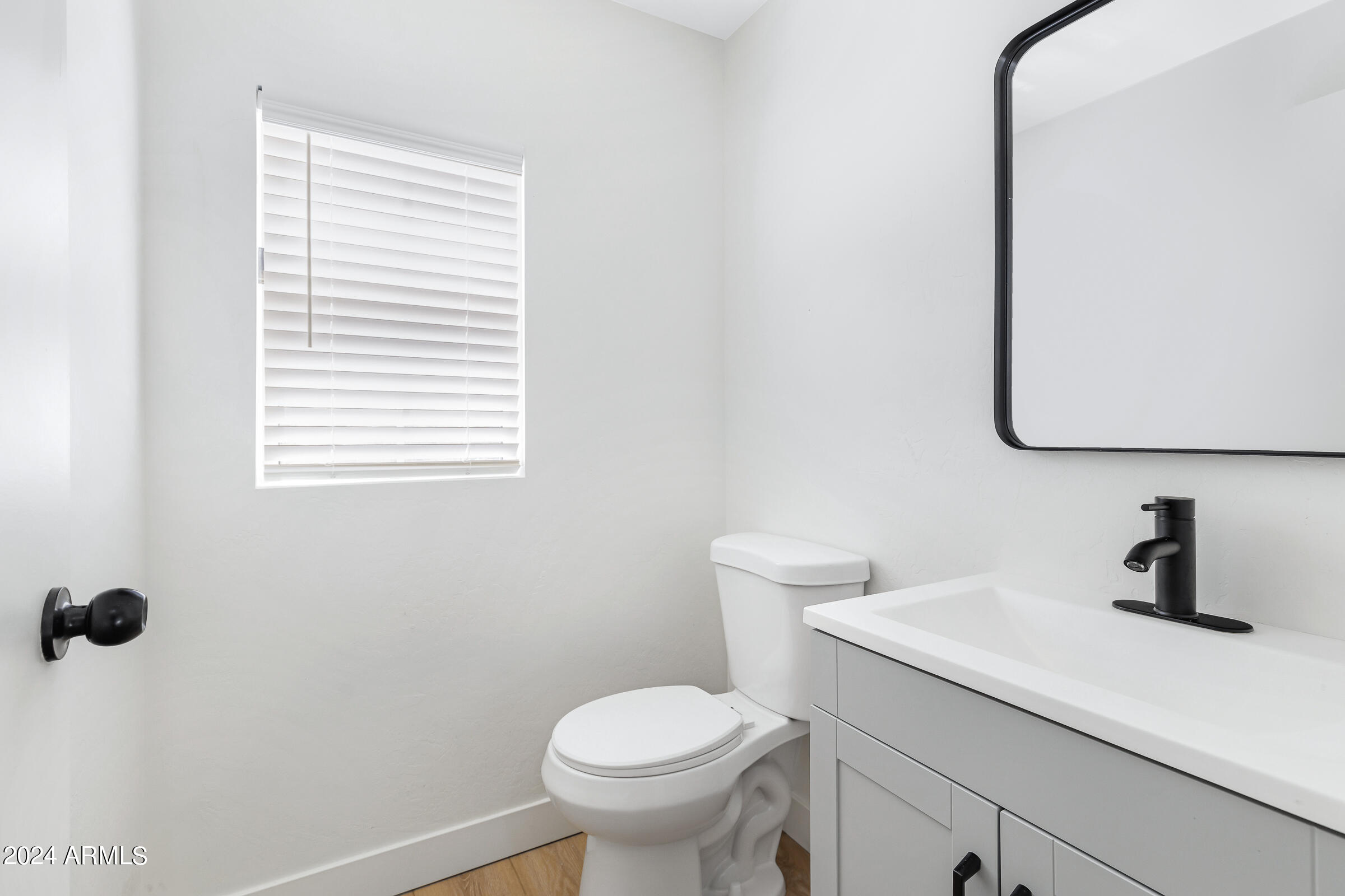 3910 West Carter Road Phoenix, AZ 85041 - Photo 20 of 40 a bathroom with a toilet sink and mirror