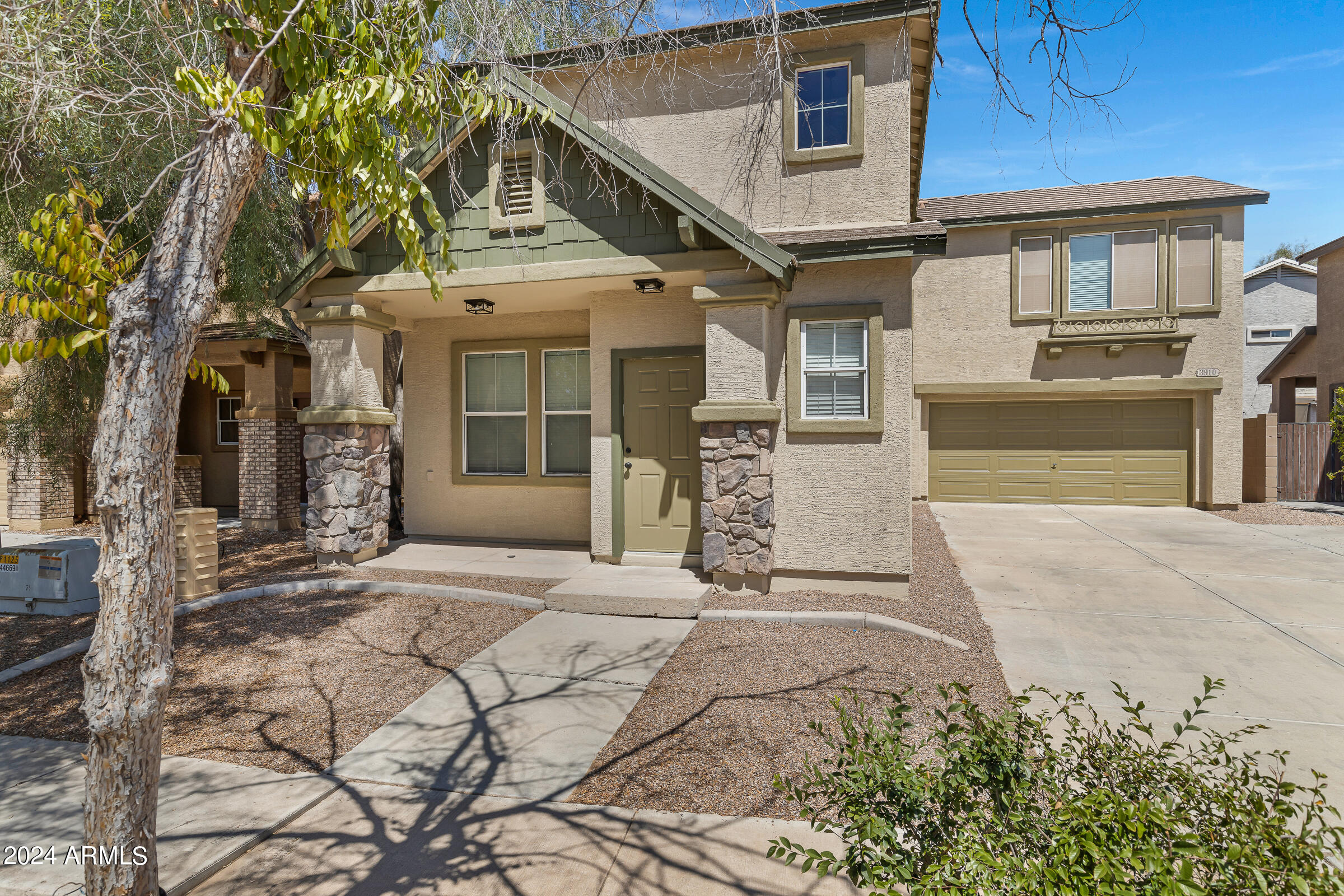 3910 West Carter Road Phoenix, AZ 85041 - Photo 2 of 40 a front view of a house with a yard and garage