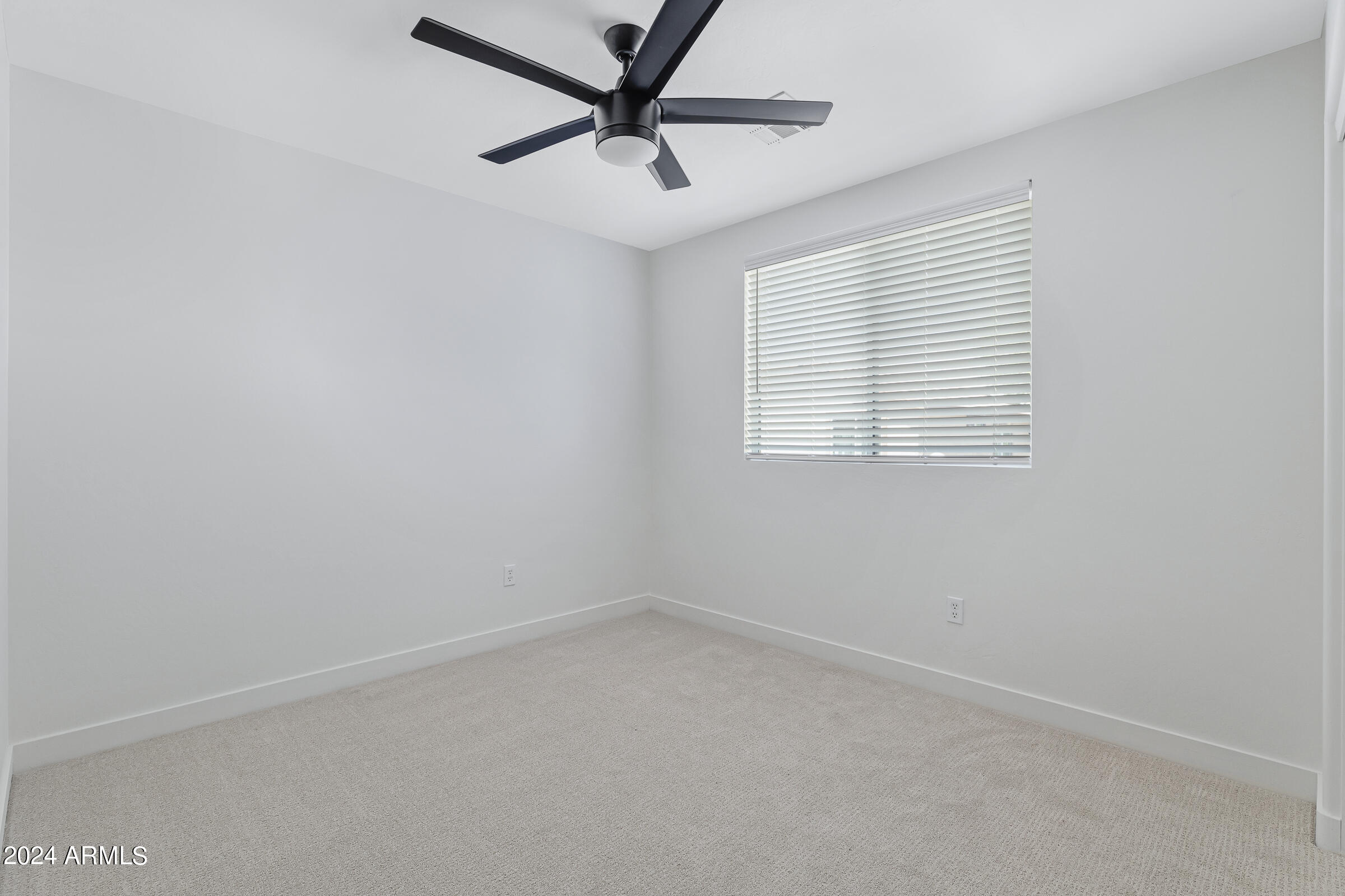 3910 West Carter Road Phoenix, AZ 85041 - Photo 28 of 40 an empty room with a window and a fan