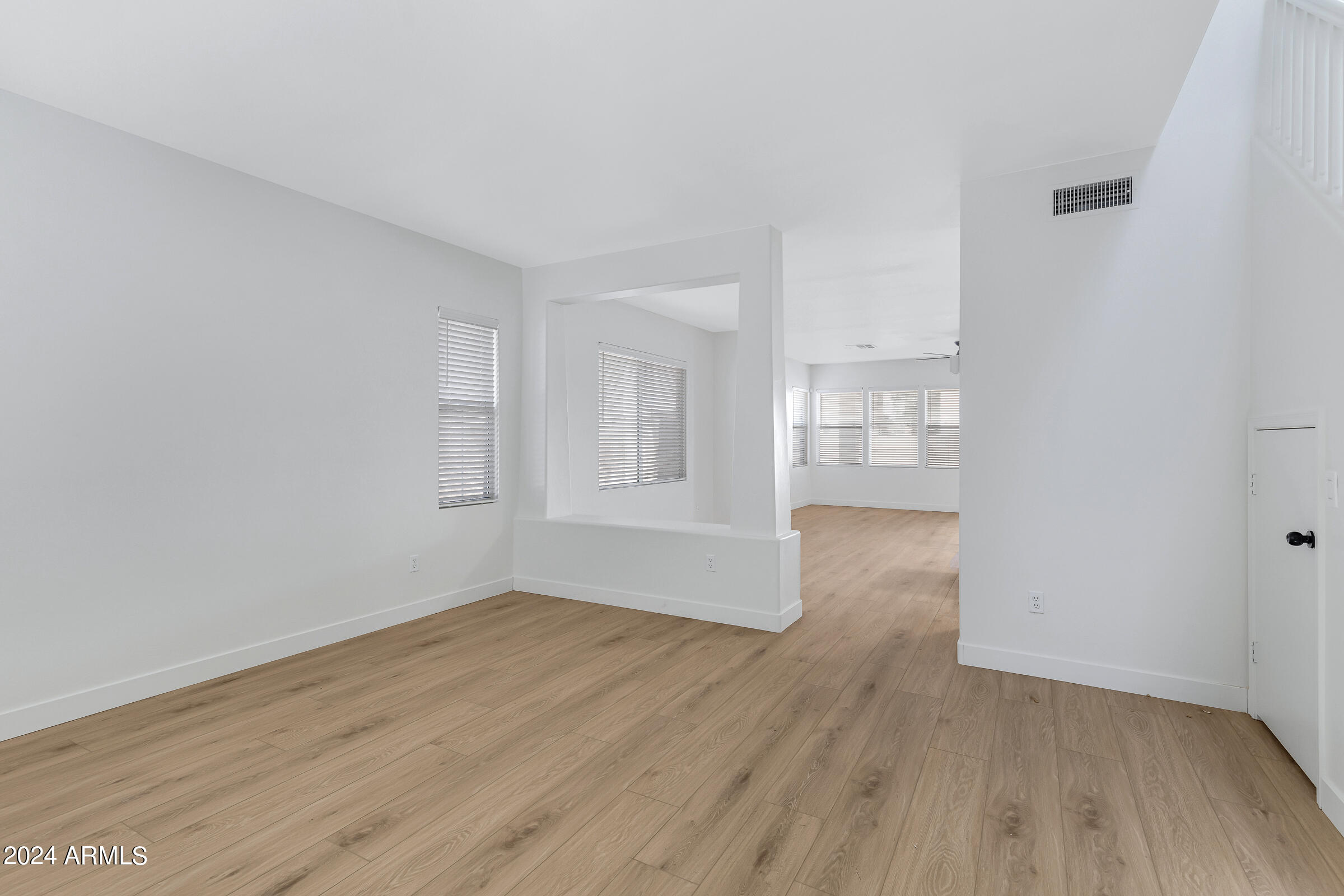 3910 West Carter Road Phoenix, AZ 85041 - Photo 5 of 40 wooden floor in an empty room with a window