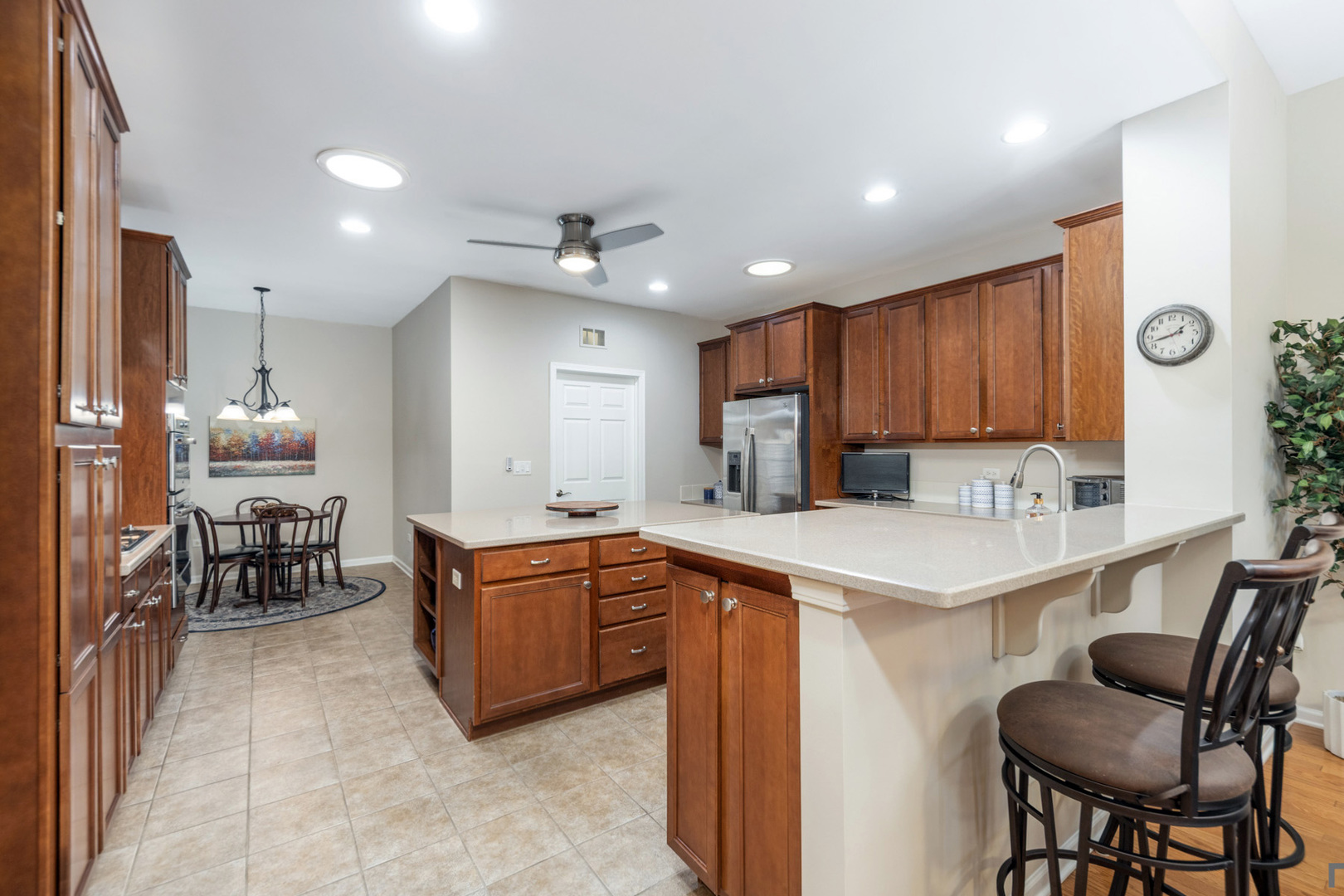 2852 Normandy Circle Naperville, IL 60564 - Photo 11 of 31 a kitchen with stainless steel appliances kitchen island granite countertop a sink and cabinets