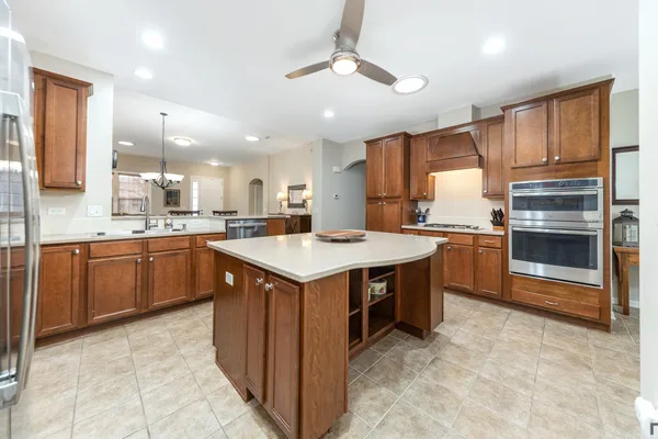 a kitchen with a sink refrigerator and cabinets
