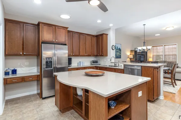 a kitchen with stainless steel appliances granite countertop a sink a stove and a refrigerator