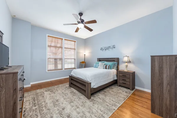 a spacious bedroom with a bed and a window