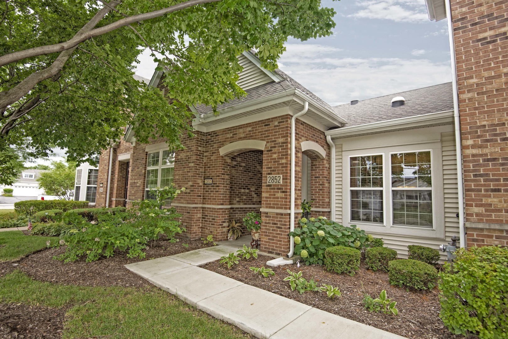 2852 Normandy Circle Naperville, IL 60564 - Photo 2 of 31 a front view of a house with garden