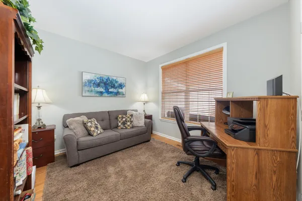 a view of a livingroom with workspace and a couch