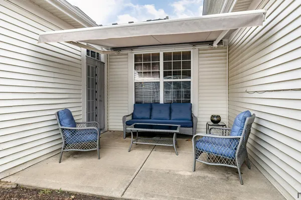 a wooden bench sitting in front of a house