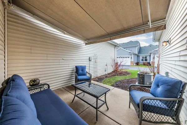 a view of backyard with seating space and couches in the patio