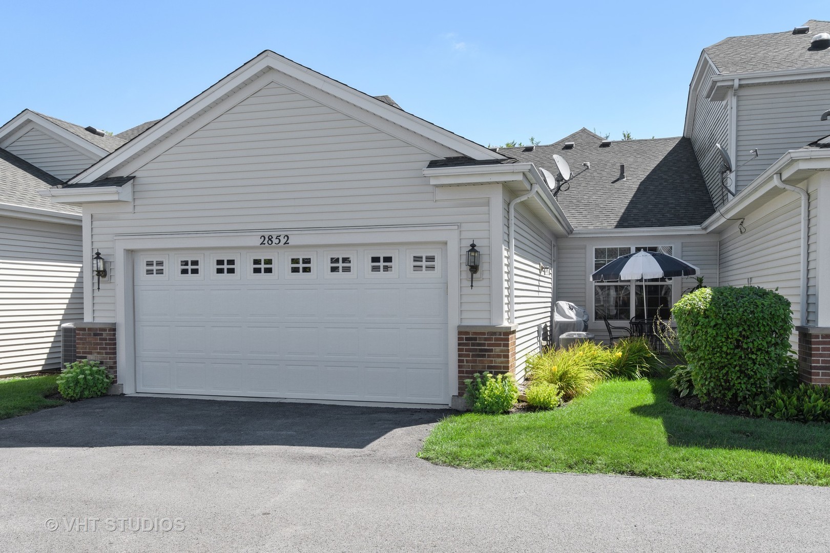 2852 Normandy Circle Naperville, IL 60564 - Photo 27 of 31 a view of a white house with a small yard and a garage