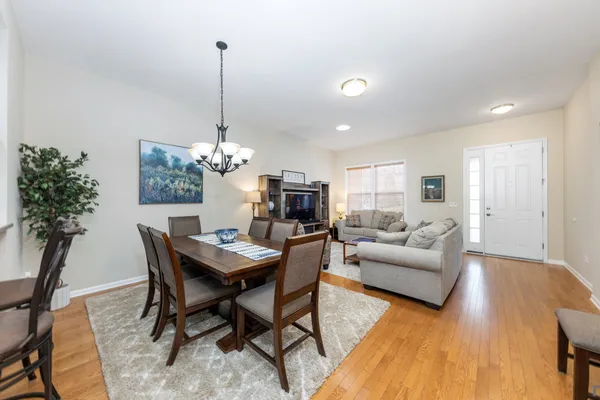 a living room with furniture and a chandelier